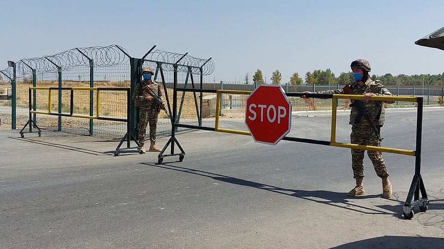 Uzbek soldiers guard a checkpoint, two kilometres from "Friendship Bridge" over the Amu Darya river, which separates Uzbekistan and Afghanistan near Termez. Credit: AFP Photo