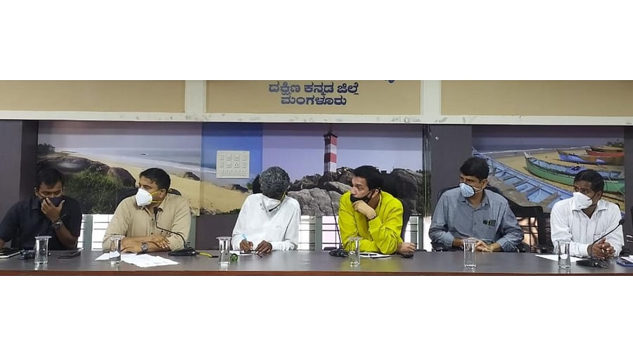 District In-Charge Minister Kota Srinivas Poojary chairs a meeting in Mangaluru.
