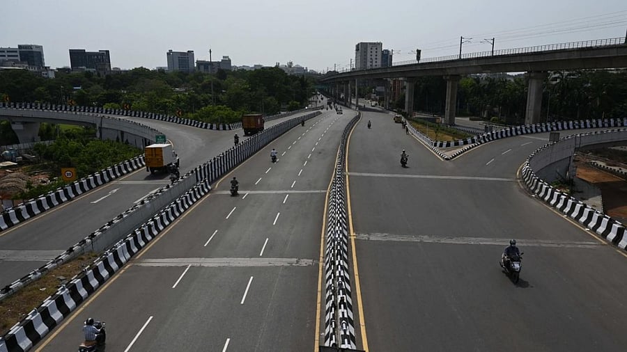 Motorists make their way through a partially deserted road after a complete lockdown was imposed by the state government as a preventive measure against the spread of the Covid-19 coronavirus in Chennai. Credit: AFP Photo
