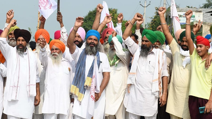 Farmers shout slogans during a protest against the central government's agricultural reforms. Credit: AFP Photo