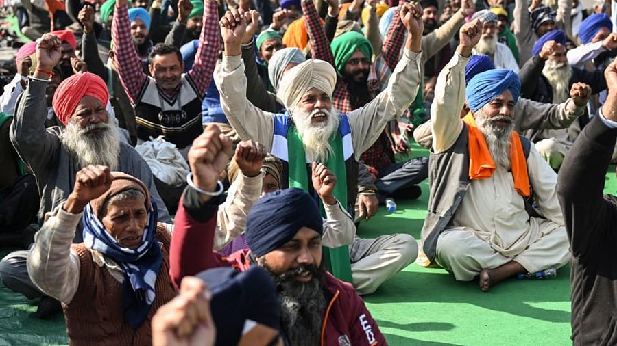 Protesting farmers shout slogans as they sit along a blocked highway during a protest against the central government's recent agricultural reforms at the Ghazipur Delhi-Uttar Pradesh state border in New Delhi on January 11, 2021. Credit: AFP Photo