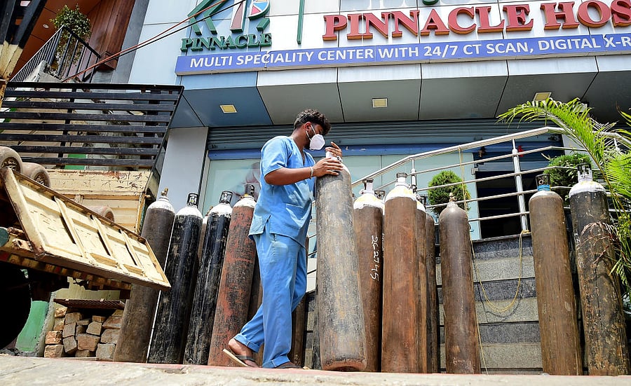 Oxygen cylinders outside a private hospital on Mysuru Road in Bengaluru on Sunday. DH PHOTO/RANJU P