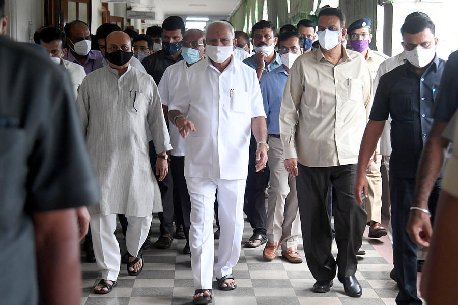 Chief Minister B S Yediyurappa, arrives in Vidhana Soudha with Ministers Basavaraj Bommai and C C Patil, for a Cabinet meeting on Thursday. DH photo/S K Dinesh