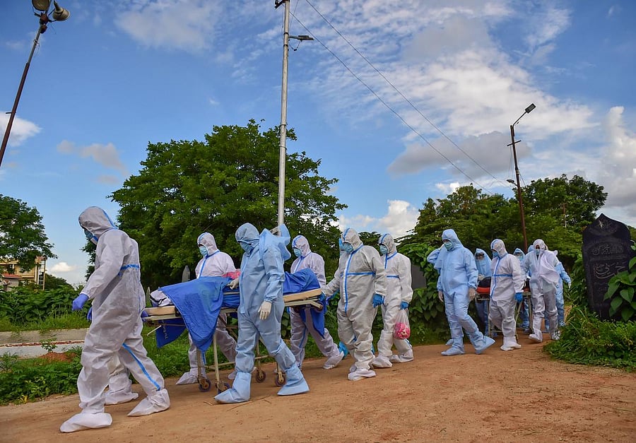 Volunteers from Mercy Angel and their helping hand team perform the last rites of a COVID-19 victim, at Khuddus Saab burial ground in Bengaluru, Saturday, July 11, 2020. Credit: PTI Photo