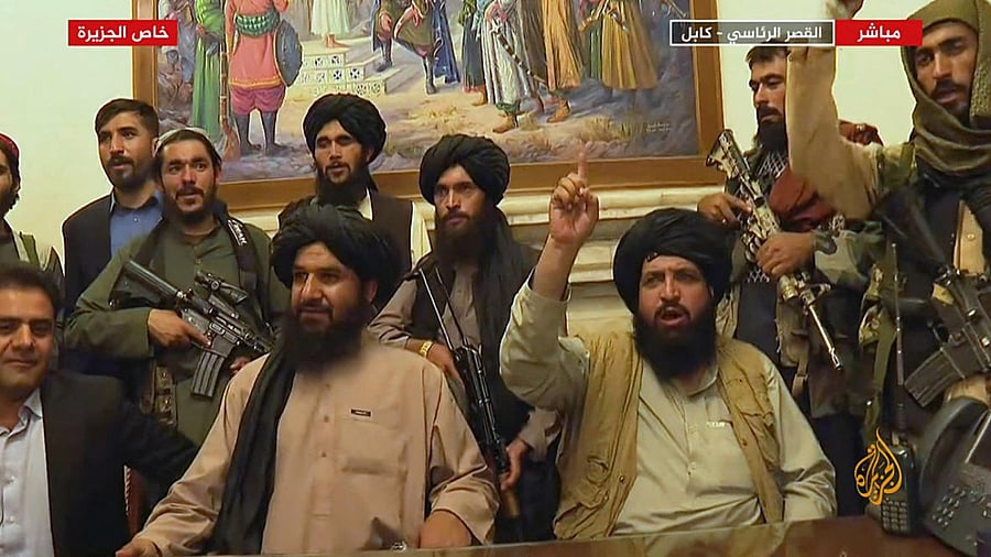 Members of Taliban taking control of the presidential palace in Kabul after Afghanistan's president flew out of the country. Credit: AFP Photo