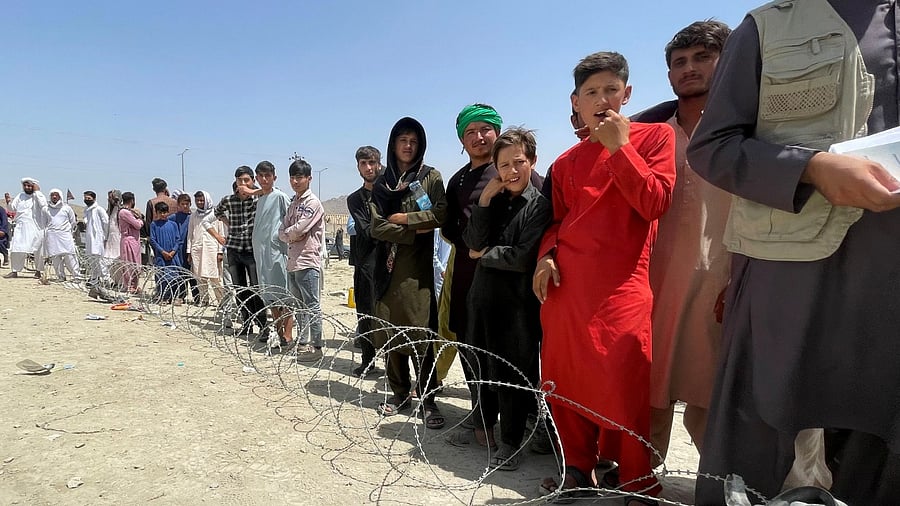 People wait outside Hamid Karzai International Airport in Kabul. Credit: Reuters File Photo