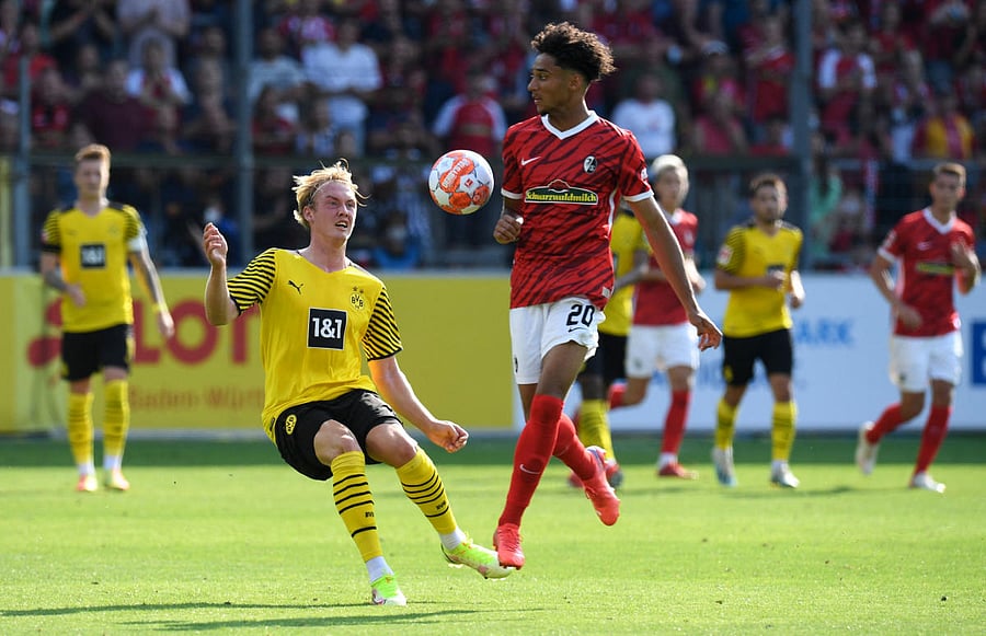 Freiburg's German forward Kevin Schade (R) and Dortmund's German forward Julian Brandt vie for the ball during the German first division Bundesliga football match. Credit: AFP Photo