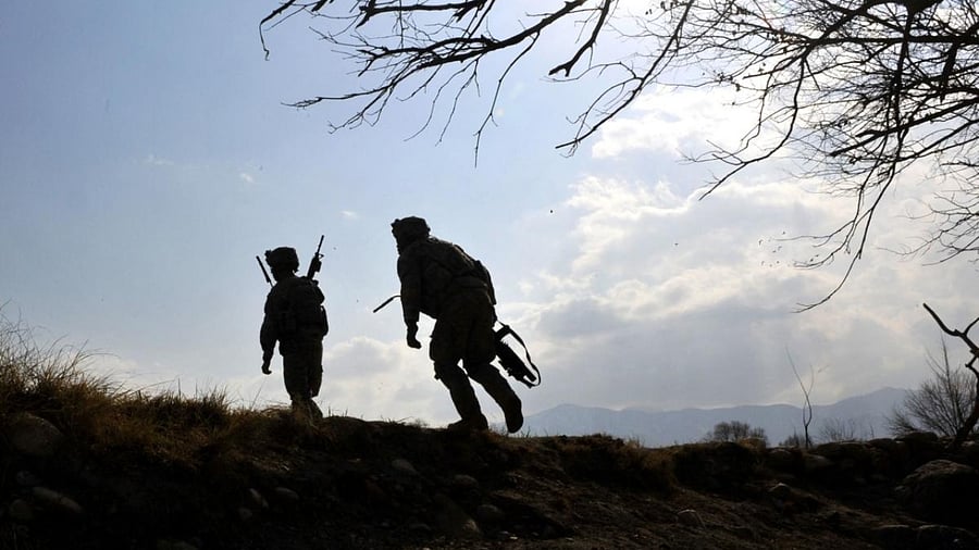 US soldiers with the 4th Infantry Division, 4th Infantry Brigade Combat Team, Alpha Company, scale a hill while on patrol in Markikheyl in eastern Afghanistan's Nangarhar province in 2010. Credit: AFP Photo