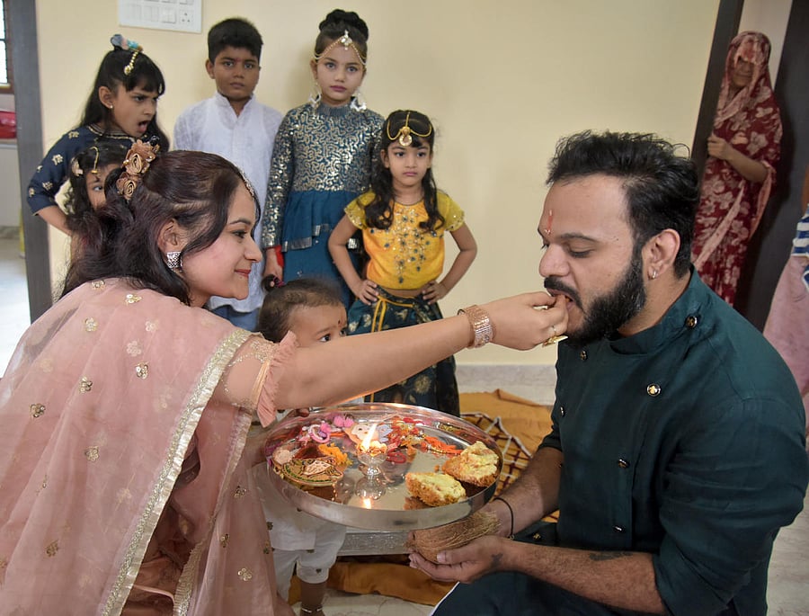 A family in Chamarajpet celebrates Rakshabandhan on Sunday. DH PHOTO/PUSHKAR V