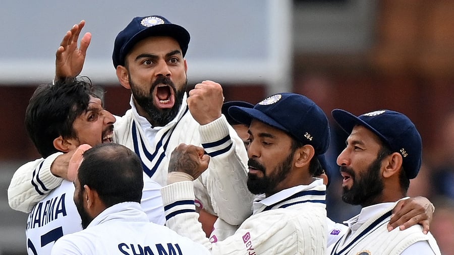 India's captain Virat Kohli (3L) celebrates with India's Ishant Sharma (L) and teammates. Credit: AFP File Photo