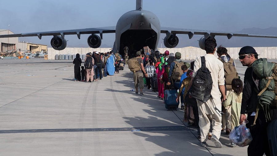 US Air Force loadmasters and pilots assigned to the 816th Expeditionary Airlift Squadron load passengers aboard a US Air Force C-17 Globemaster III in support of the Afghanistan evacuation at Hamid Karzai International Airport (HKIA), Afghanistan. Credit: AFP Photo/US Air Force/Master Sgt. Donald R Allen