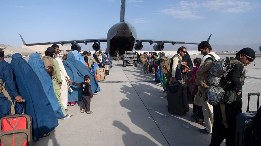 US Air Force loadmasters and pilots assigned to the 816th Expeditionary Airlift Squadron, load passengers aboard a US Air Force C-17 Globemaster III in support of the Afghanistan evacuation at Hamid Karzai International Airport (HKIA), Afghanistan. Credit: AFP Photo/US Air Force/Master Sgt. Donald R Allen