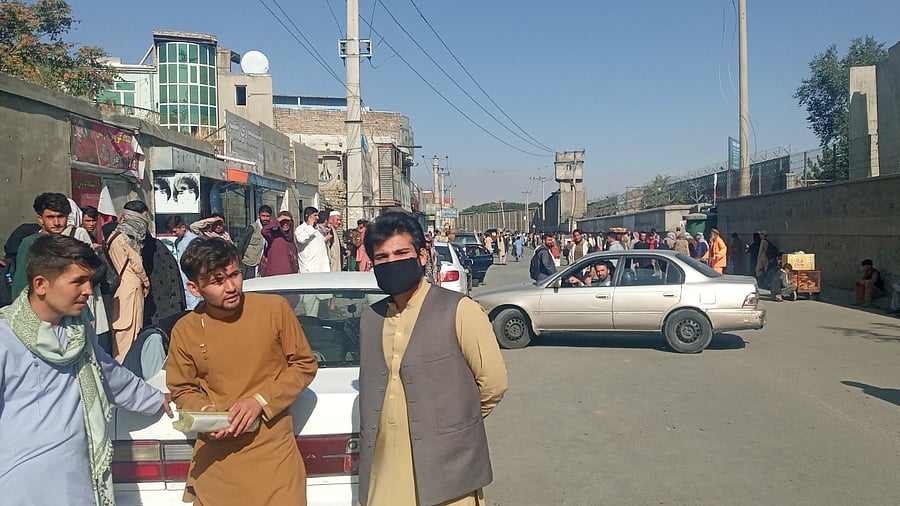 People walk a street near the Baron Hotel around Abbey Gate of Kabul's airport. Credit: Reuters Photo