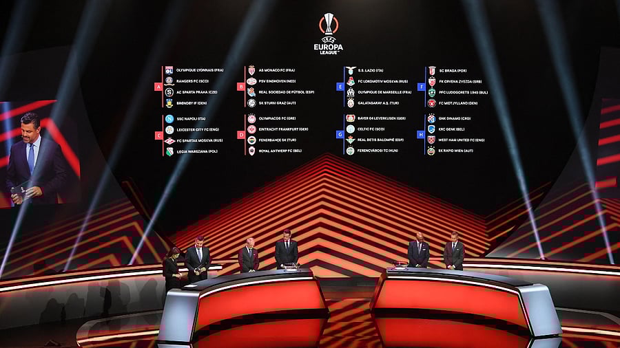 A screen displays the groups for the UEFA Europa League. Credit: AFP Photo