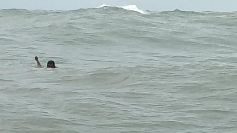 Nawaz waiting for rescue by holding a piece of thermocol in the sea near estuary in Ullal. Credit: Special arrangement
