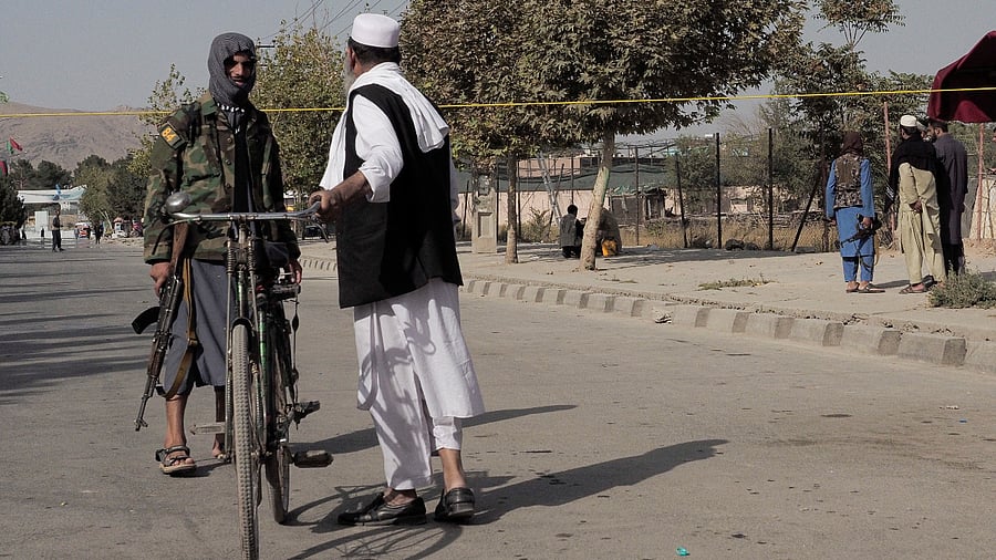 A Taliban fighter guards a street leading to the Abbey Gate at Hamid Karzai International Airport in Kabul, Afghanistan. Credit: Reuters Photo
