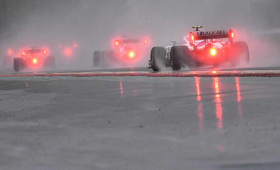 Drivers follow the safety car during preliminary laps of the Belgian Grand Prix at the Spa-Francorchamps circuit. Credit: AFP Photo