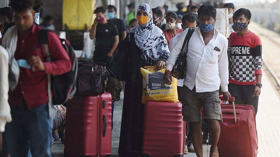  Passengers wait in queues to give swab samples for the Covid-19 testing after arriving at Lokmanya Tilak Terminus railway Station in Mumbai. Credit: PTI Photo