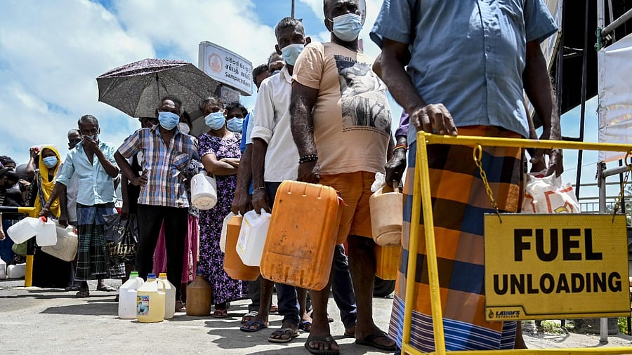 People stand in a queue to buy kerosene oil used in cooking stoves in Colombo on August 31, 2021 following Sri Lanka's declaration of state of emergency over food shortages as private banks ran out of foreign exchange to finance imports. Credit: AFP Photo