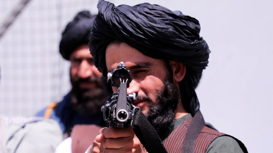 Taliban forces stand guard in front of Hamid Karzai International Airport in Kabul. Credit: Reuters Photo