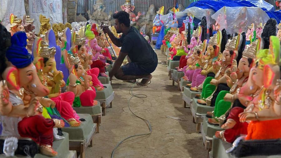 An artisan paints to give finishing touches to a clay idol of elephant-headed Hindu god Ganesha ahead of the Ganesh Chaturthi festival in Bangalore. Credit: AFP Photo