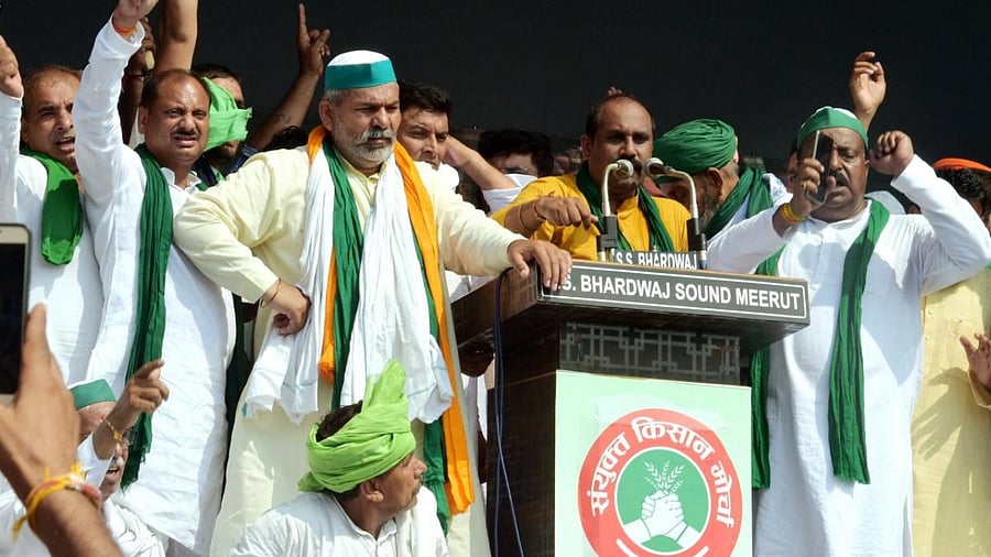Bharatiya Kisan Union spokesperson Rakesh Tikait with others during a 'Kisan Mahapanchayat' over the ongoing farmers' agitation against Centre's farm reform laws, in Muzaffarnagar. Credit: PTI photo