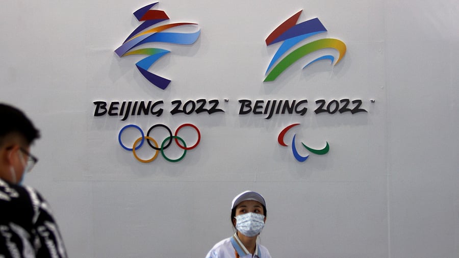 A woman walks past signs for the 2022 Olympic and Paralympic Winter Games at the 2021 China International Fair for Trade in Services (CIFTIS) in Beijing, China September 3, 2021. Credit: Reuters Photo