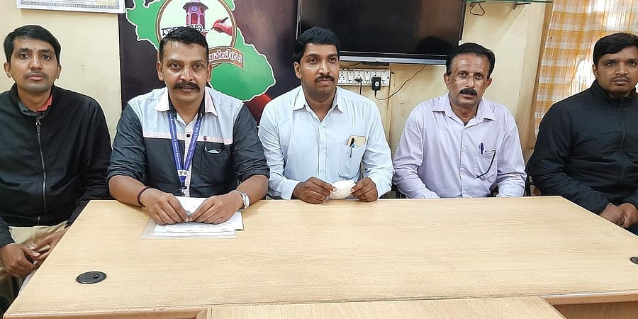 Members of the State Government Employees' Association speak at a press conference in Virajpet on Wednesday.