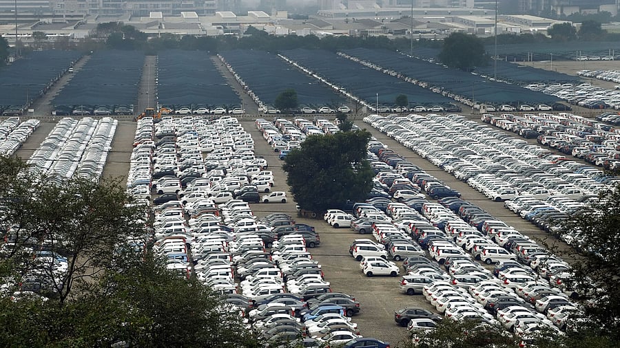 Newly manufactured Maruti Suzuki cars are seen parked inside the company factory in Manesar near Gurugram. Credit: PTI File Photo