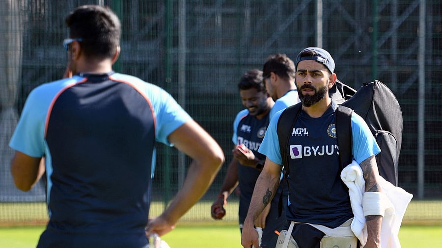 Ravichandran Ashwin (L) talks with captain Virat Kohli during a team practice session. Credit: AFP Photo