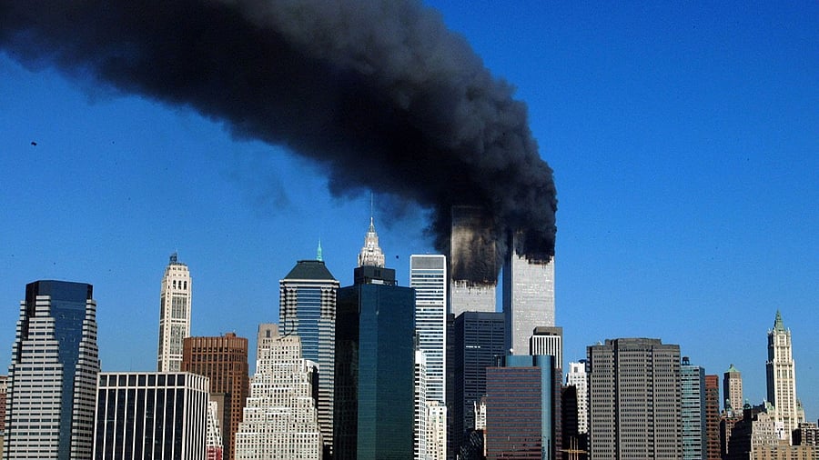 The twin towers of the World Trade Center billow smoke after hijacked airliners crashed into them. Credit: AFP File Photo