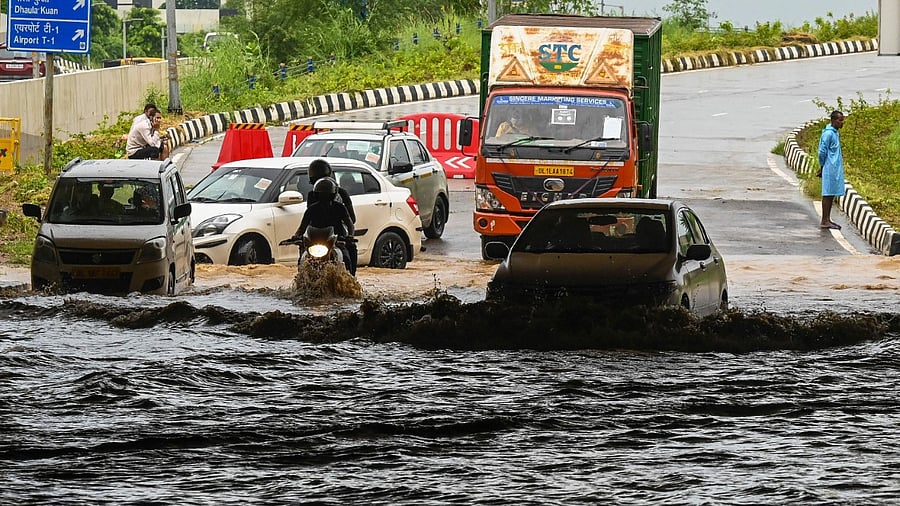 Motorists make their way along a waterlogged underpass during a downpour in New Delhi. Credit: AFP Photo