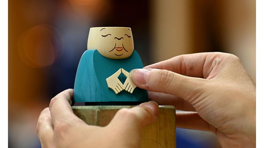 An incense smoker featuring German Chancellor Angela Merkel making her typical "rhombus" hand gesture. Credit: AFP Photo