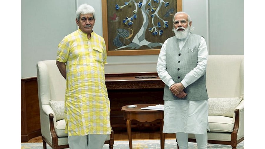 J&K Lieutenant Governor Manoj Sinha and Prime Minister Narendra Modi. Credit: PTI File Photo