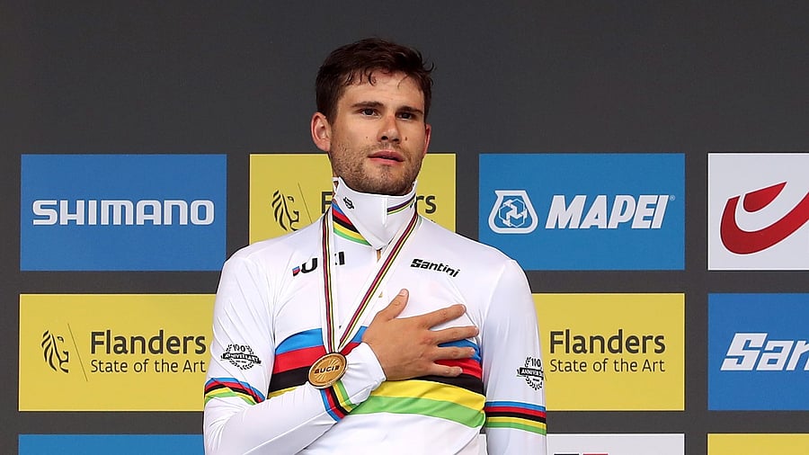 Ganna celebrates with his medal on the podium. Credit: Reuters Photo