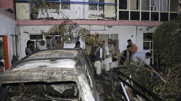 Afghan people are seen inside a house after U.S. drone strike in Kabul, Afghanistan. Credit: AP Photo