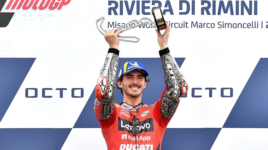Francesco Bagnaia celebrates on the podium. Credit: Reuters Photo