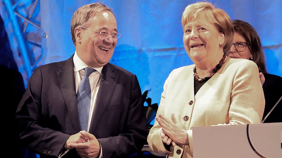 Armin Laschet, chairman of the German Christian Democratic Union (CDU) and the party's top candidate for the federal election, left, and German chancellor Angela Merkel attend a joint campaign appearance in Stralsund, Germany. Credit: AP/PTI Photo