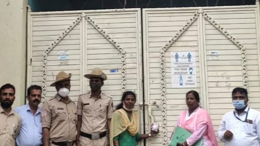 Mysuru City Corporation officials seal Shalimar Function Hall at NR Mohalla in Mysuru on Wednesday. Credit: DH Photo