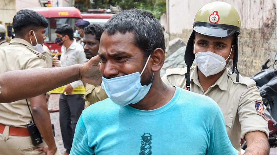 A man grieves the death of a relative in the blast at New Tharagupet, Bengaluru, on Thursday. Credit: DH Photo/M S Manjunath