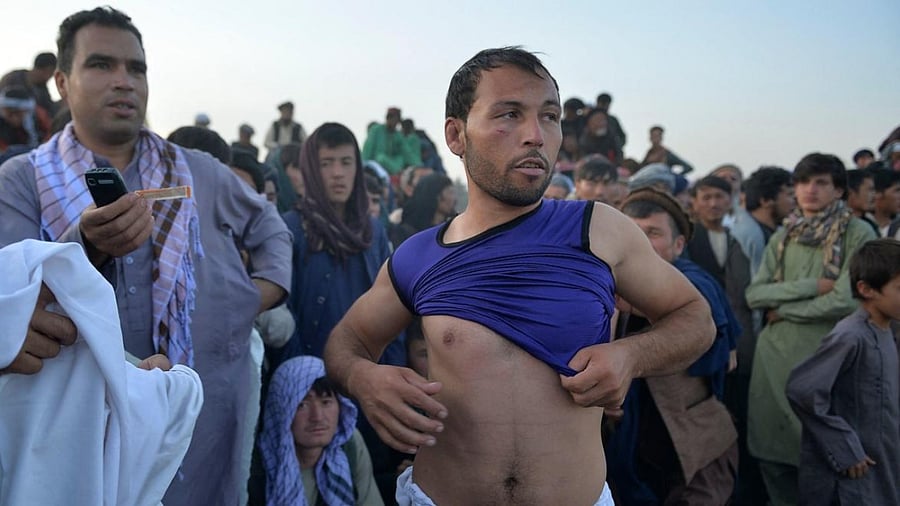 A fighter preparing before competing in a judo and wrestling gathering in Chaman-e-Huzuri park, downtown Kabul. Credit: AFP Photo