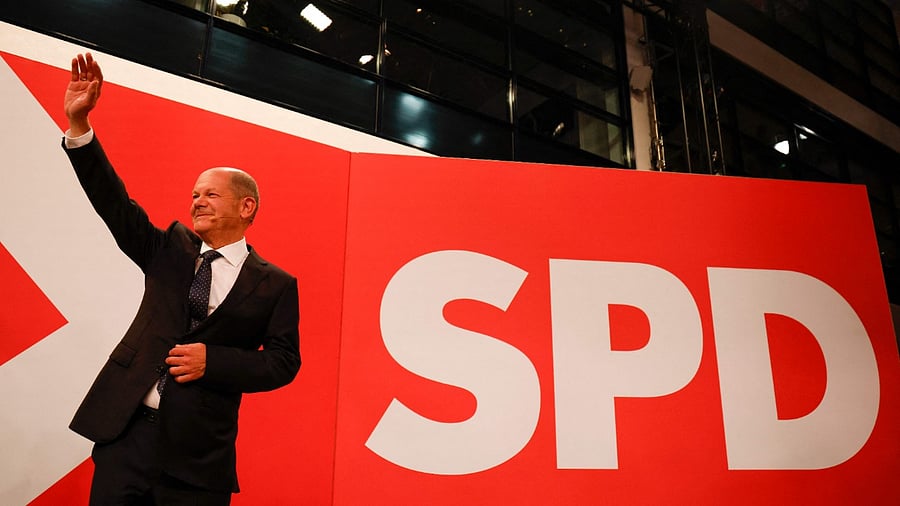 German Finance Minister, Vice-Chancellor and the Social Democrats (SPD) candidate for Chancellor Olaf Scholz waves on stage at the Social Democrats (SPD) headquarters after the estimates were broadcast on TV in Berlin on September 26, 2021 after the German general elections. Credit: AFP Photo