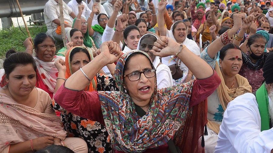 Farmers raise slogans as they block the Jalandhar-Delhi National Highway during their 'Bharat Bandh'. Credit: PTI Photo