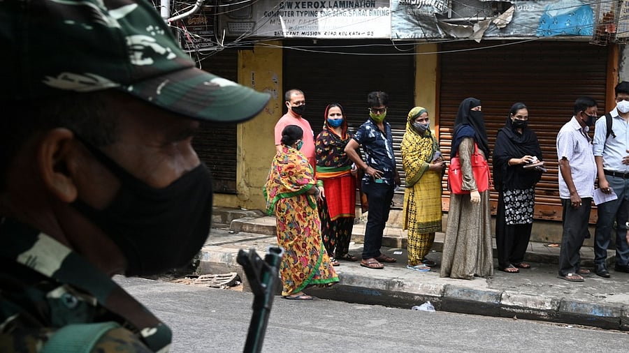 People queue outside a polling station to cast their vote for the by-election of Bhabanipur legislative assembly seat. Credit: AFP Photo
