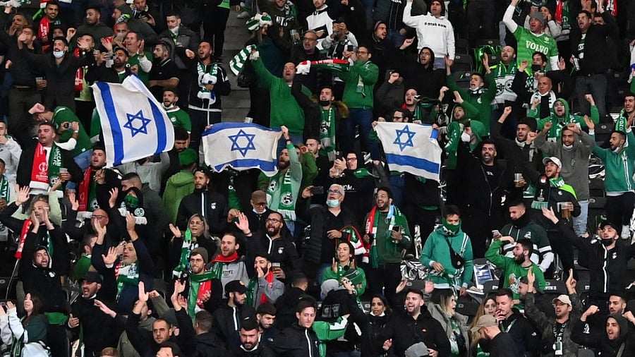 Israel's Maccabi Haifa fans display Israeli flags in the stands, during the UEFA Conference League Group E first leg football match between FC Union Berlin and Maccabi Haifa in the Olympic Stadium in Berlin. Credit: AFP Photo