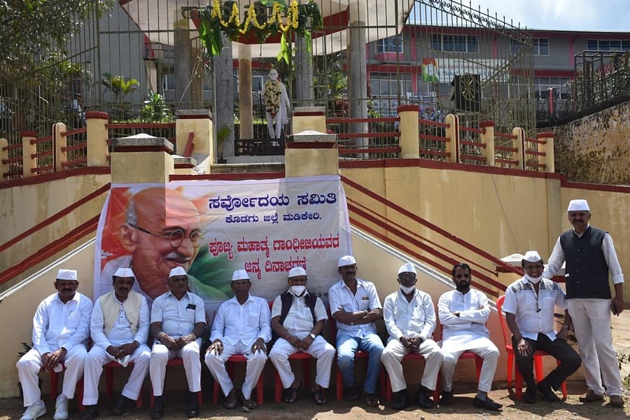 Dignitaries take part in the Gandhi Jayanti programme observed by Sarvodaya Samiti at Gandhi Maidan in Madikeri.