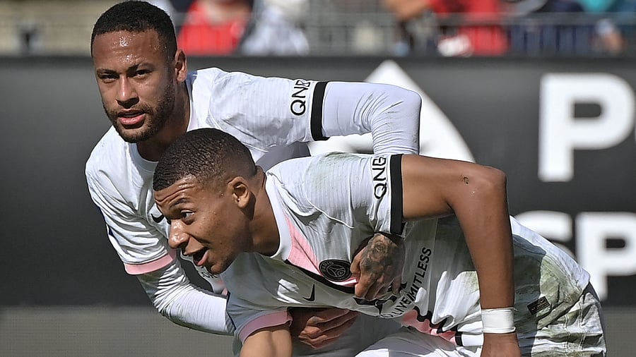 Paris Saint-Germain's French forward Kylian Mbappe (R) is helped by teammate Paris Saint-Germain's Brazilian forward Neymar (L) during the French L1 football match. Credit: AFP Photo