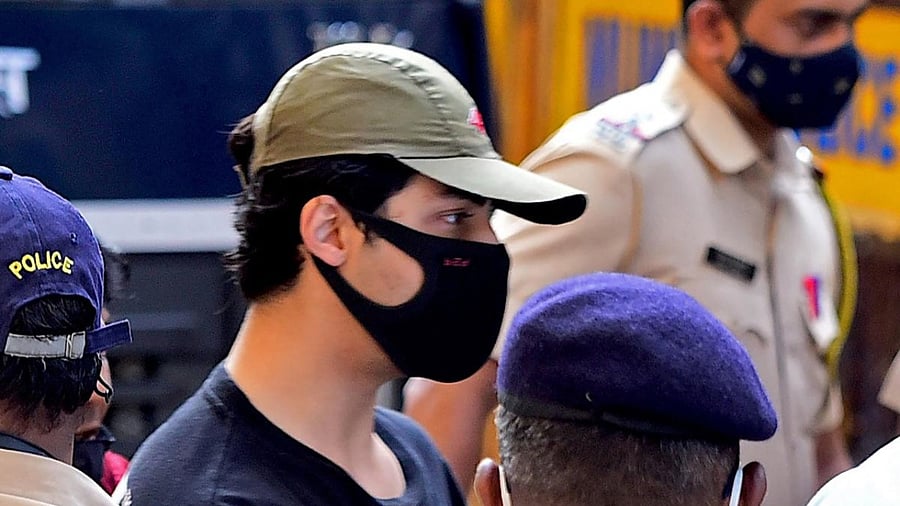 Bollywood actor Shah Rukh Khan's son Aryan Khan being escorted by officals. Credit: AFP Photo