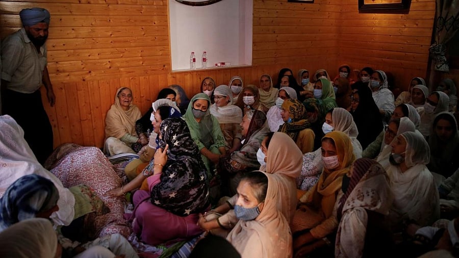 Relatives mourn around the body of Kour, a school teacher, who was shot and killed by suspected militants in Srinagar. Credit: Reuters photo