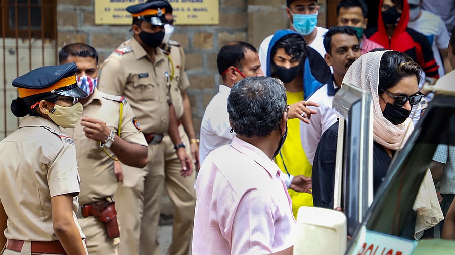 ollywood actor Shah Rukh Khan's son Aryan Khan (wearing blue) leaves for hospital from Narcotics Control Bureau's office. Credit: PTI Photo